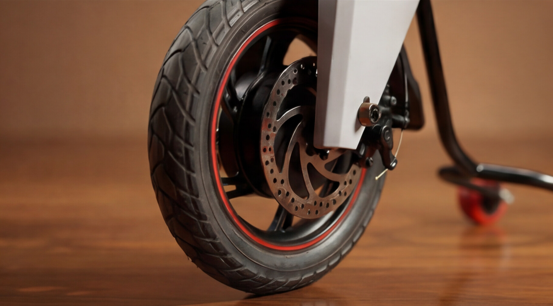 Close-up of VGO front wheel and disc brake showing premium mobility engineering details.