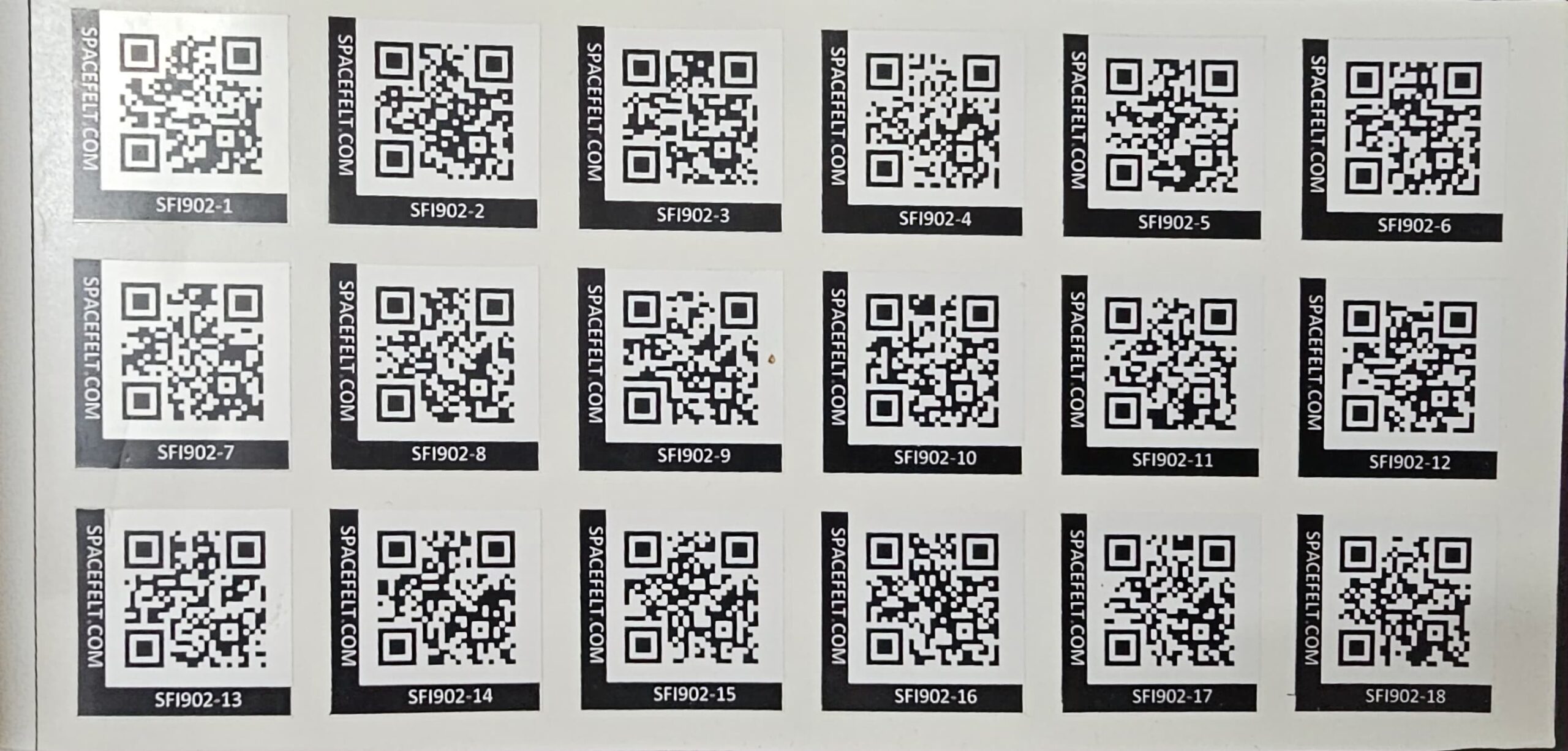 Page of the Spacefelt labelling booklet showing multiple QR code stickers arranged in rows with unique tag IDs.