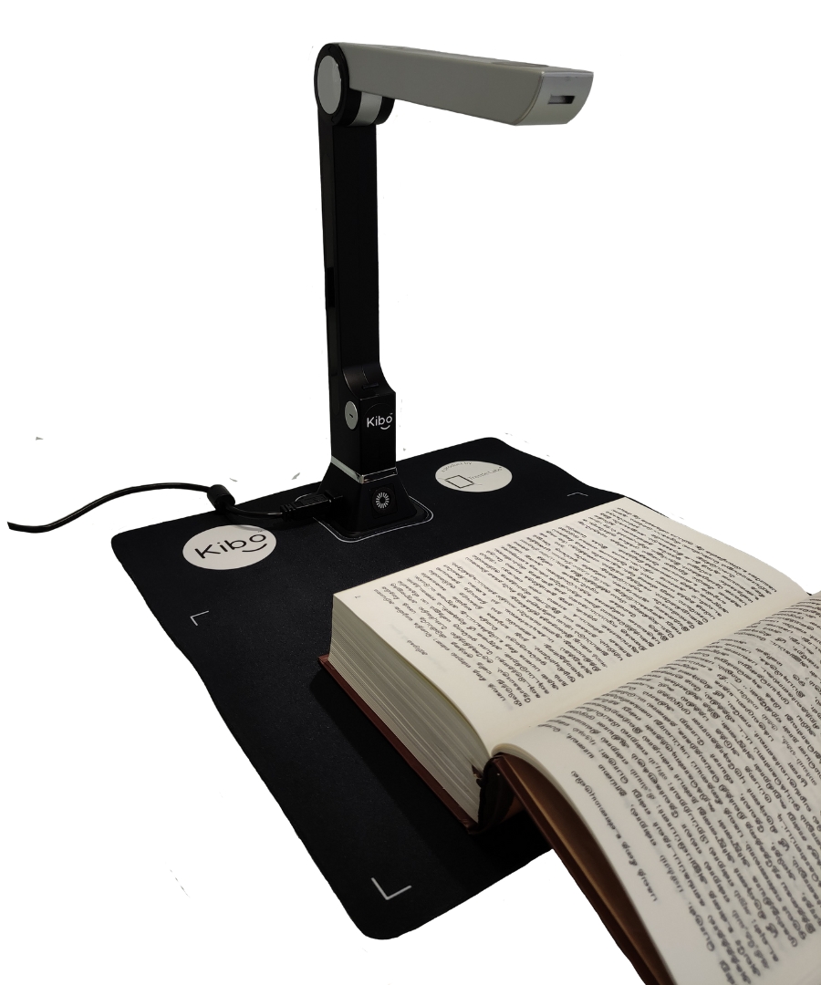 Kibo 1.0 Kit image (Table-lamp like hardware device placed on a mouse pad material A4 sized mat. A book is placed on the mat)
